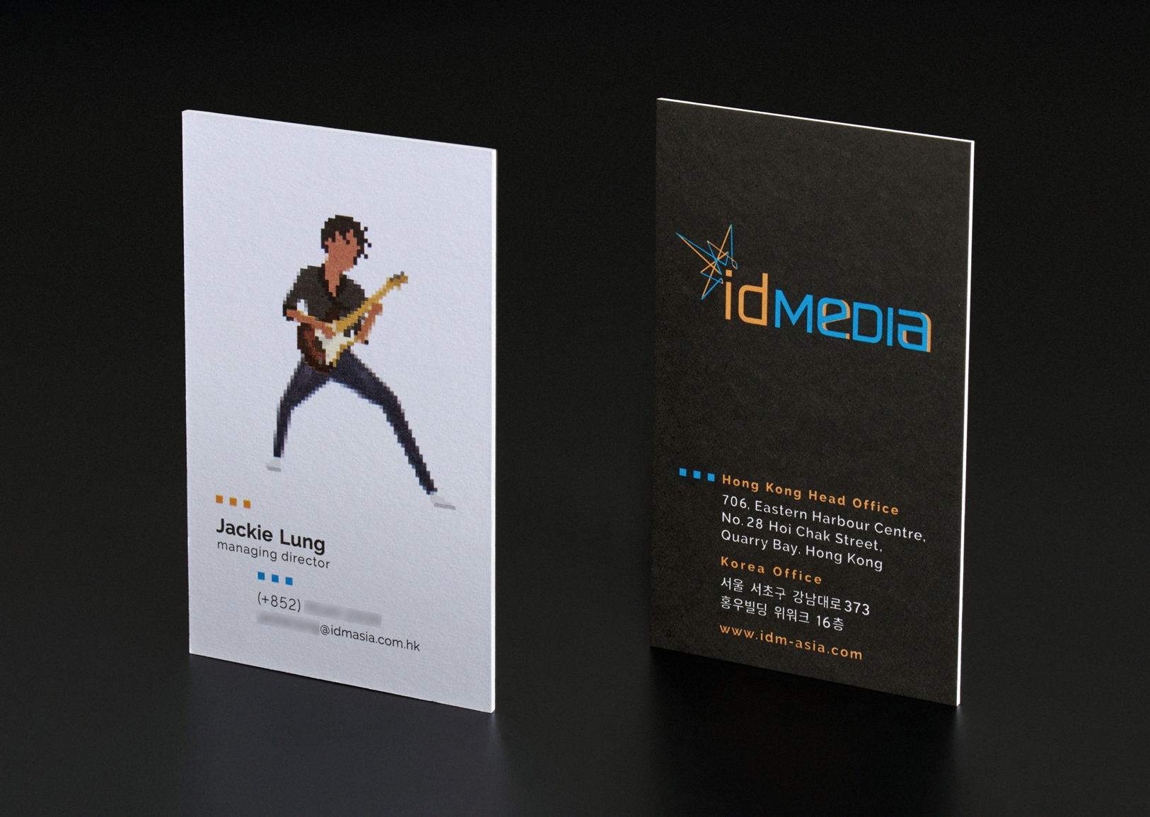 A leading Asian Digital Marketing Agency Brand based in Hong Kong and office in South Korea :: Identity Revamp and New Business Card Design :: business card, name card, dynamic branding, personalisation pixelated figures of every individuals, black table top, anglar view, 1 executive, JL guitarist in action, front and back standing