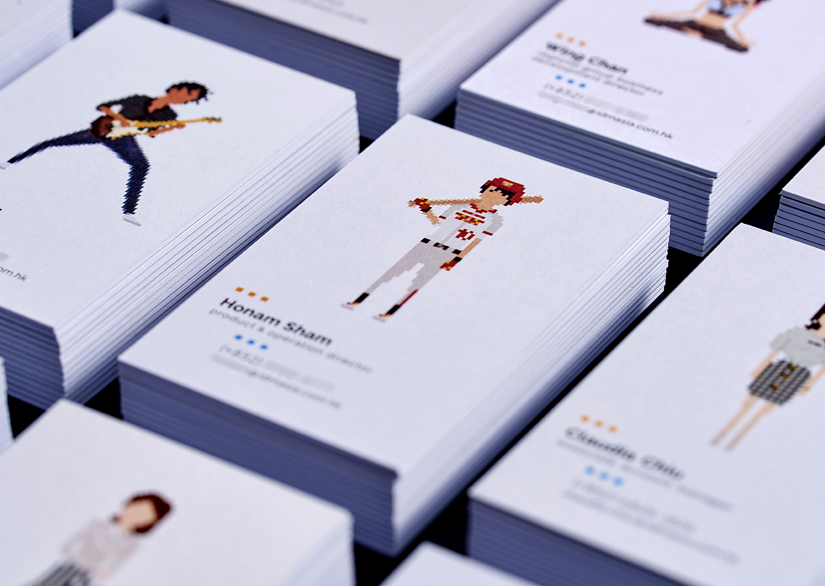 A leading Asian Digital Marketing Agency Brand based in Hong Kong and office in South Korea :: Identity Revamp and New Business Card Design :: business card, name card, 12 decks, 3 x 4 array, dynamic branding, personalisation pixelated figures of every individuals, black table top, focusing HS baseball player, anglar view