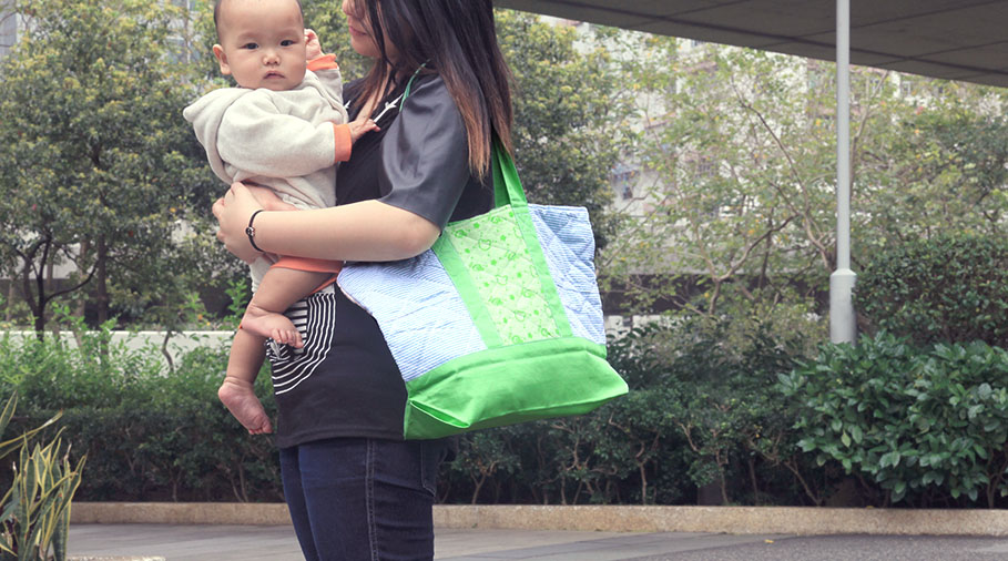 Green Baby Garden :: Retail Imaging of Upcycling Product :: carrying melon green parent bag on shoulder